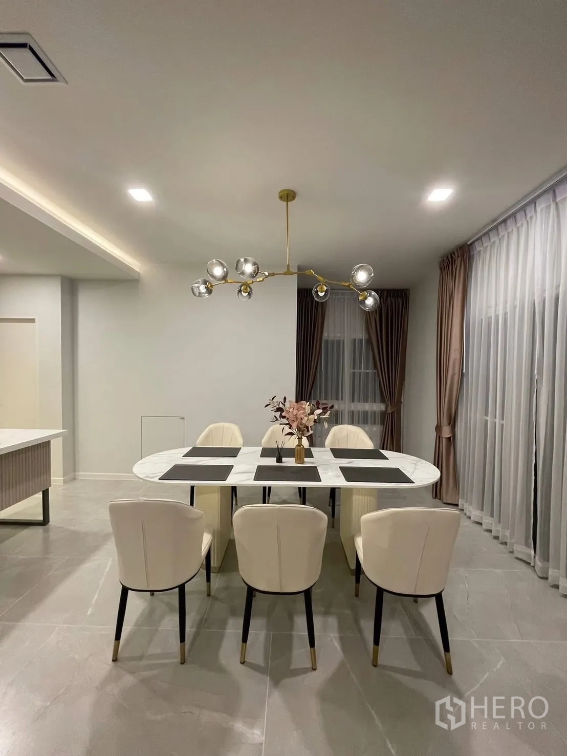 Detached House for rent in Prawet, Bangkok - Bright dining room with floor-to-ceiling curtains and soft lighting.