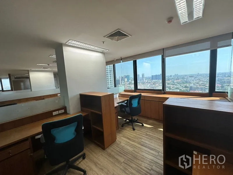 Office Space for rent or sale - Corner workstation beside panoramic windows with city views and daylight.