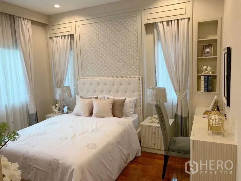 Detached House for rent or sale in Bang Phli, Samut Prakan - Cozy bedroom with tufted headboard, built-in shelves and twin windows.