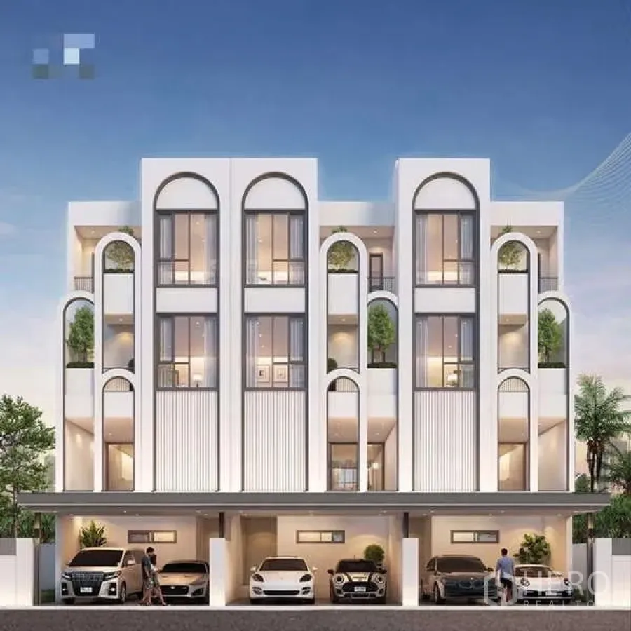 Townhouse for sale - Street-level view of a townhouse row with arched architecture and multiple covered carports.