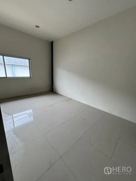 Warehouse for rent in Krathum Baen, Samut Sakhon - Second-floor office room with window and glossy tile floor.