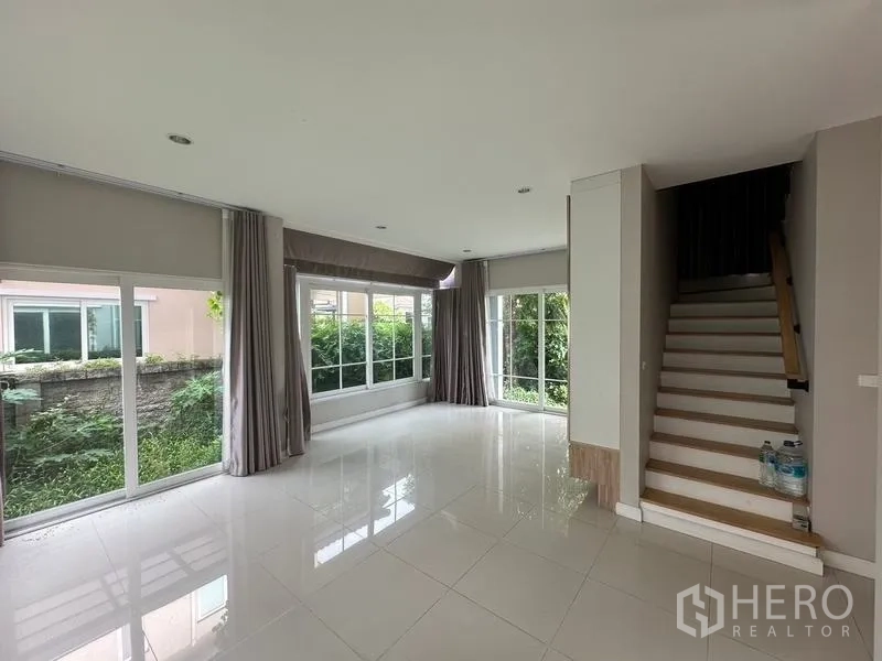 Detached House for sale in Bang Khen, Bangkok - Open-plan ground floor with many windows and a staircase to the upper level.