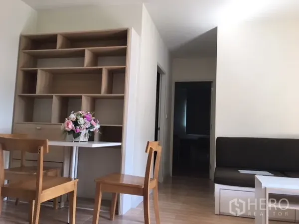 Condominium for rent in Phra Khanong, Bangkok - Built-in shelving with dining set and compact sofa in a tidy two-bedroom condo interior.