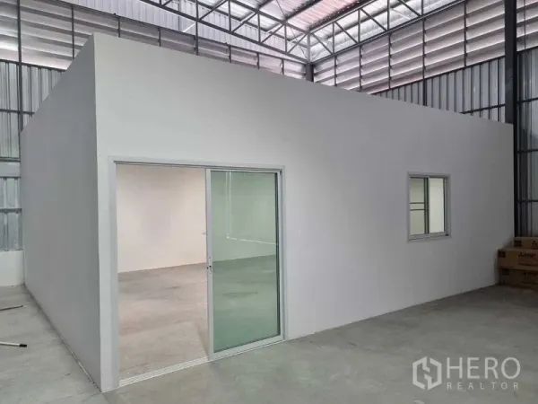 Warehouse for rent in Khlong Sam Wa, Bangkok - Enclosed office room with sliding glass door and window inside the warehouse.