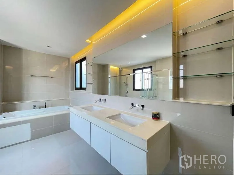 Detached House for rent in Bang Sue, Bangkok - Large bathroom with double vanity, wide mirror and glass shelving.