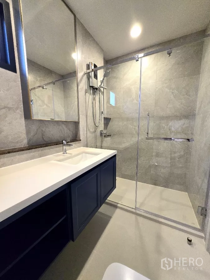 Detached House for rent in Bang Phli, Samut Prakan - Bathroom with glass shower enclosure and long vanity.