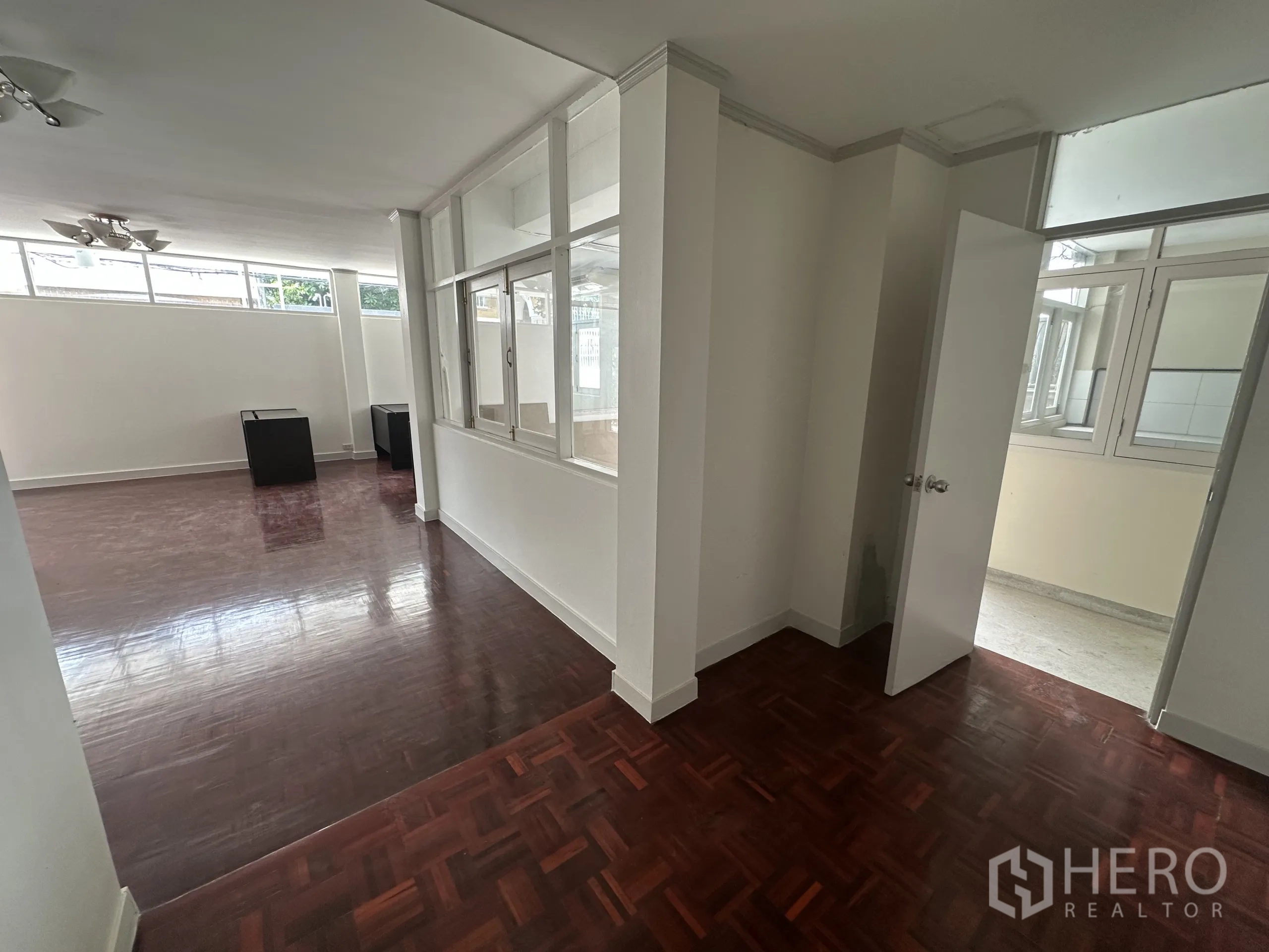 Home Office for rent in Watthana, Bangkok - Hallway with glass partition walls connecting to a private room or meeting space.