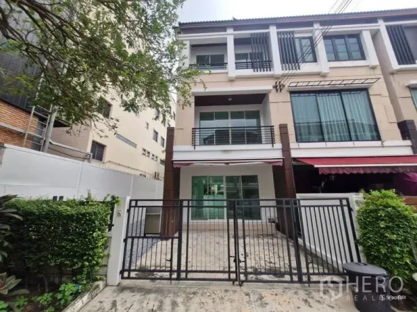 Detached House for sale in Rat Burana, Bangkok - Front elevation of modern three-storey detached home behind a black gate.