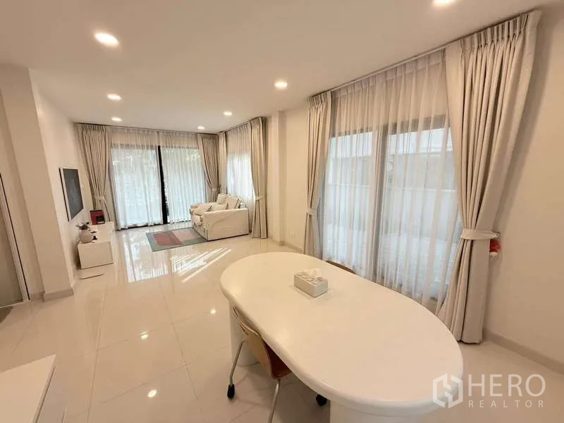 Detached House for sale in Bang Phli, Samut Prakan - Living and dining area with full-height windows and sliding doors to the patio.