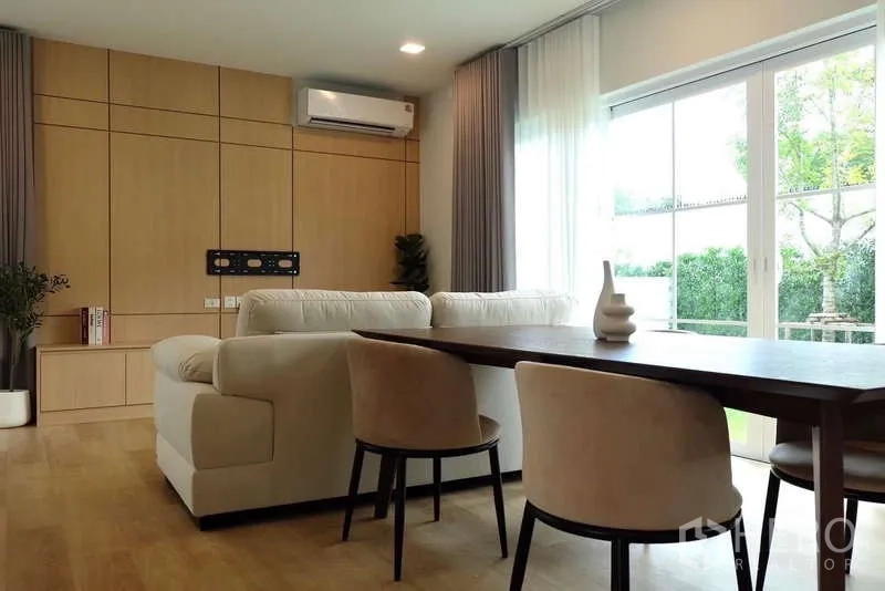 Detached House for rent in Bang Phli, Samut Prakan - Dining space beside living room with sliding doors and wood feature wall.