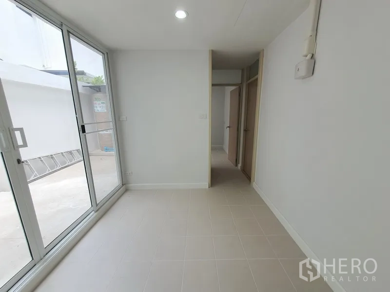 Townhouse for rent in Phaya Thai, Bangkok - Tiled utility or pantry room with sliding glass doors opening to a rear terrace.