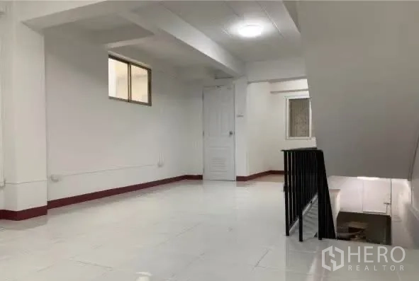 Home Office for rent in Sathon, Bangkok - Bright landing with white floors and a stair railing leading to rooms.