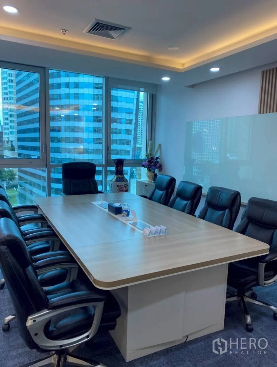 Office Space for rent in Sathon, Bangkok - Conference room with a large meeting table, leather chairs and city views through wide windows.