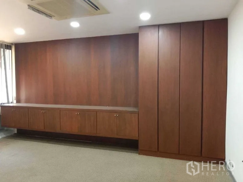 Office Space for rent in Watthana, Bangkok - Private office with full-height wooden cabinets and overhead lights.