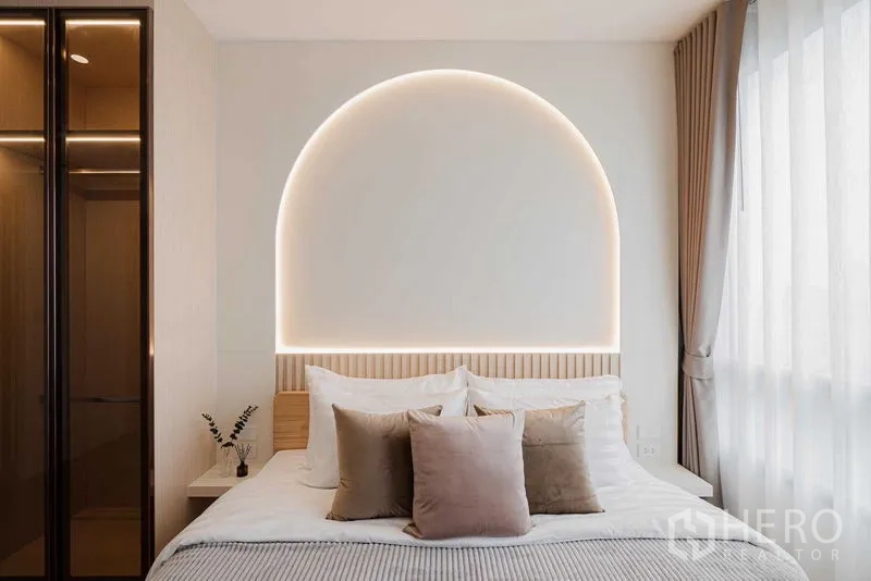 Condominium for rent in Watthana, Bangkok - Close-up of bed with curved backlit headboard and sheer curtains.