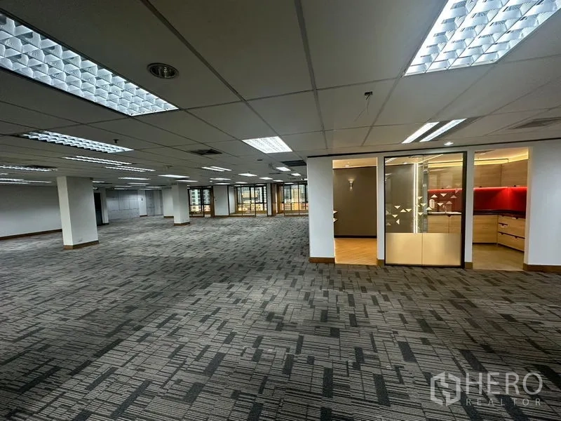 Office Space for rent in Khlong Toei, Bangkok - Expansive office floor with a glass meeting room and red accent cabinetry.