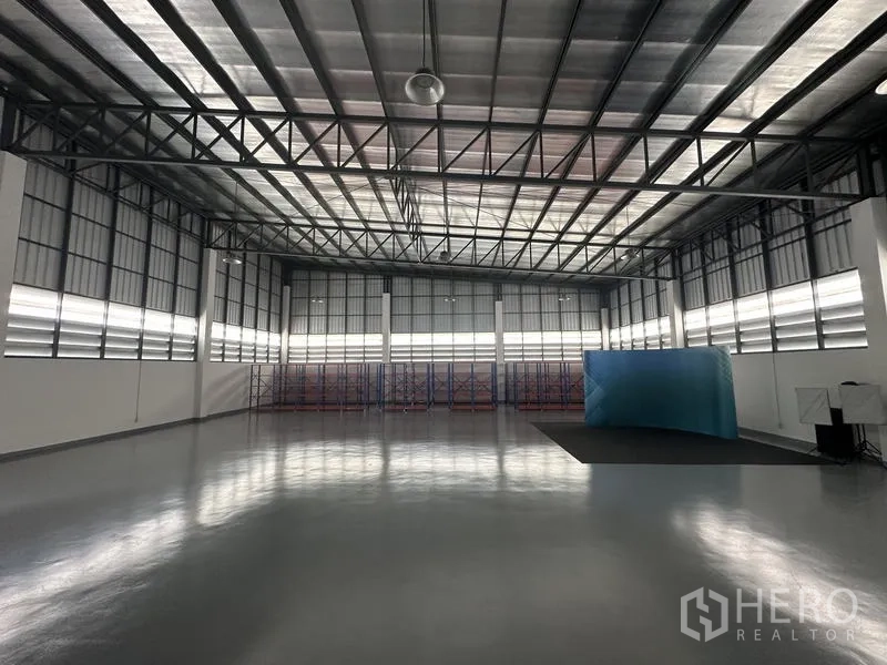 Factory for sale in Lam Luk Ka, Pathum Thani - Spacious high-ceiling warehouse with steel truss roof and epoxy floor.