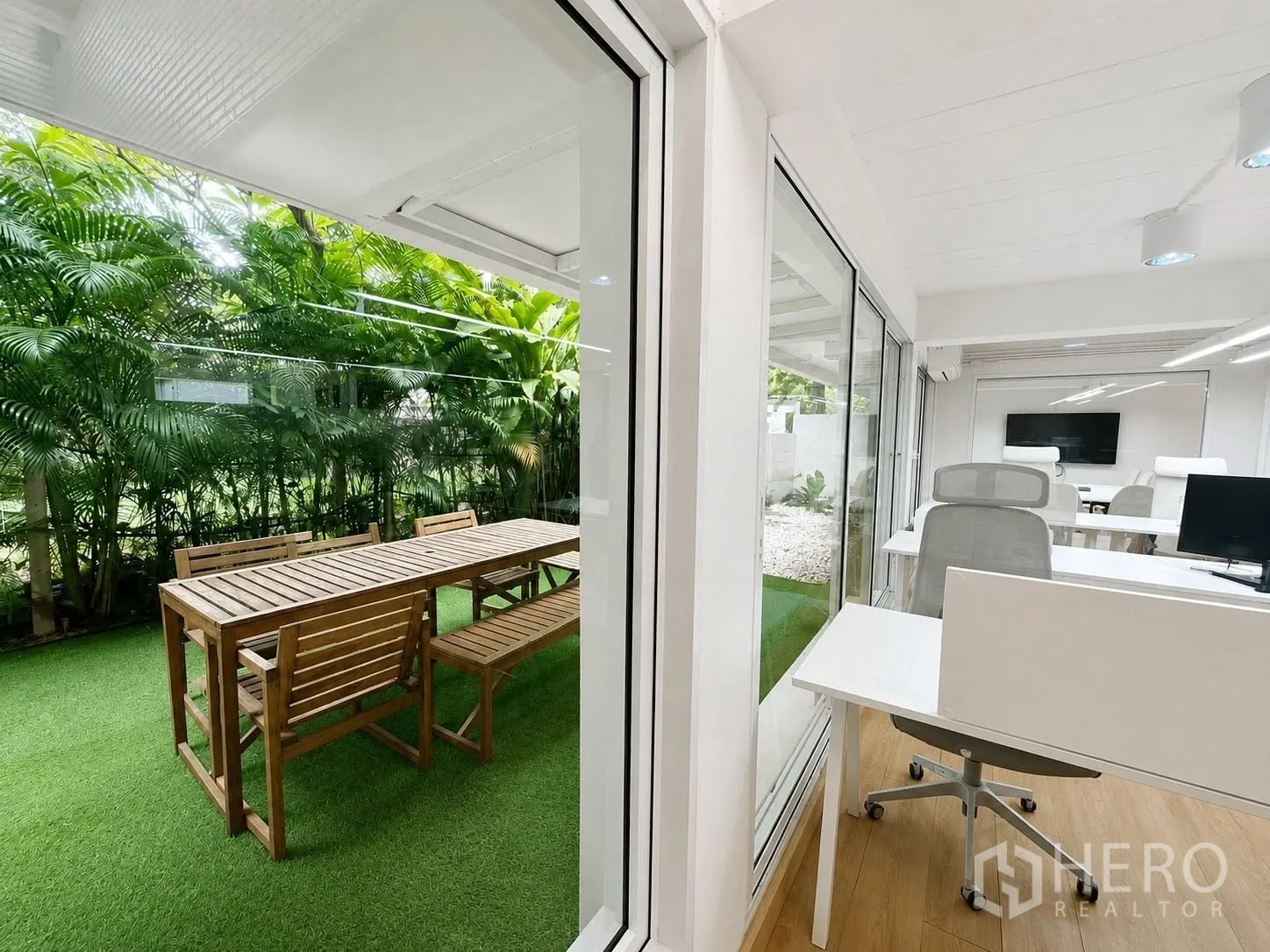 Office Space for rent in Phaya Thai, Bangkok - Workstations with garden view through large glass panels.