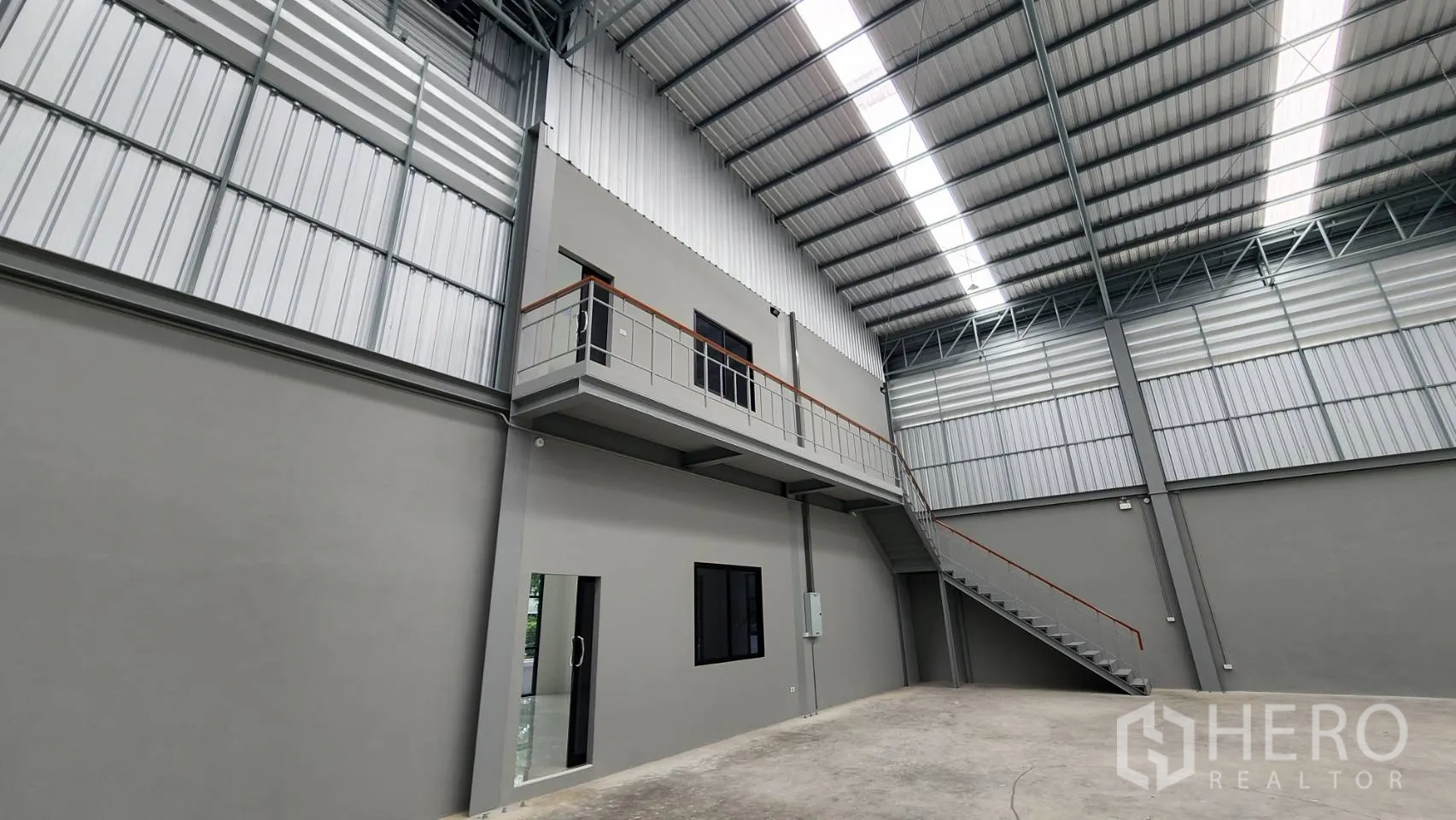 Factory for rent or sale in Bang Bo, Samut Prakan - Internal office block with windows and access door beneath the high, well‑lit roof.