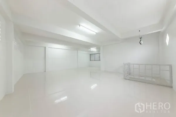 Home Office for sale in Bang Kho Laem, Bangkok - Bright white office floor with glossy tiles, fluorescent lighting and stairwell railing.