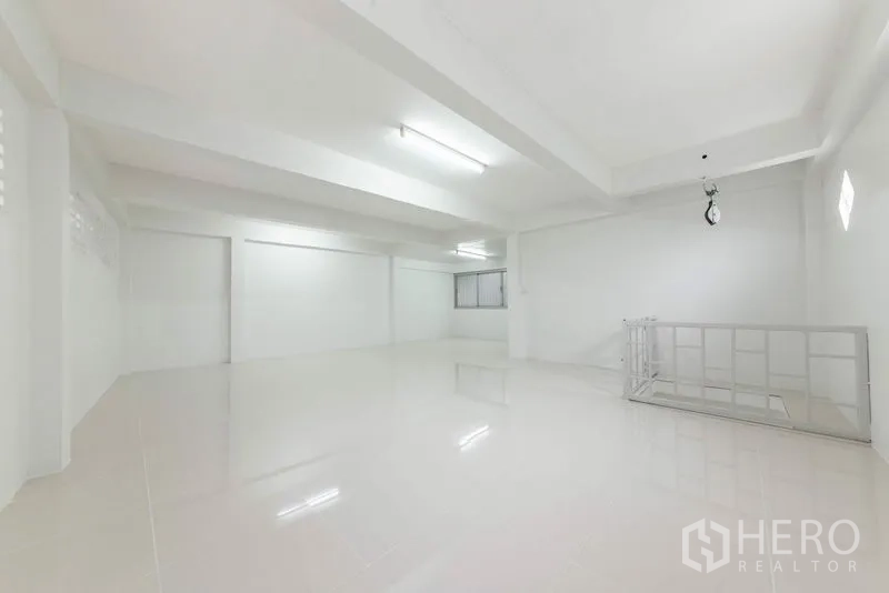 Home Office for sale in Bang Kho Laem, Bangkok - Bright white office floor with glossy tiles, fluorescent lighting and stairwell railing.