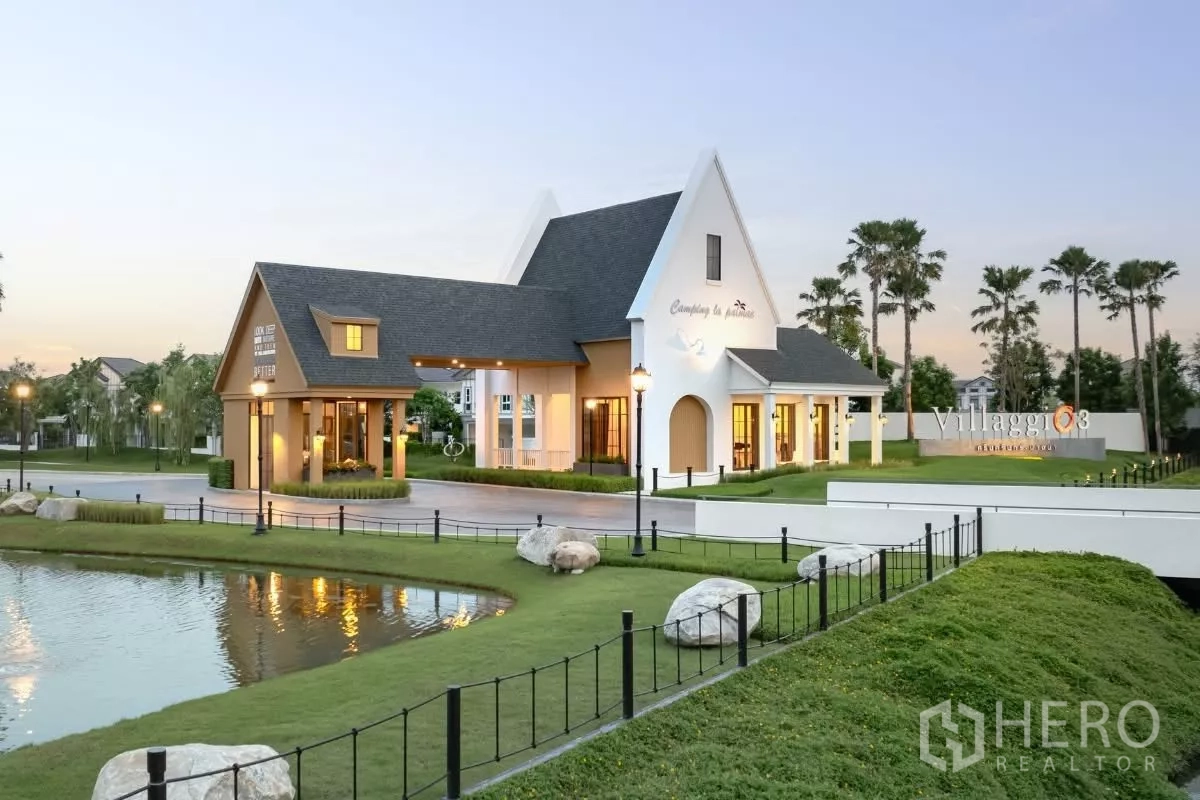 Detached House for rent in Bang Phli, Samut Prakan - Project entrance and clubhouse beside a pond in a resort-style setting.