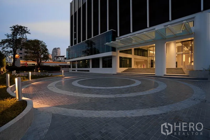Office Space for rent in Sathon, Bangkok - Evening view of the illuminated entrance plaza and covered canopy.