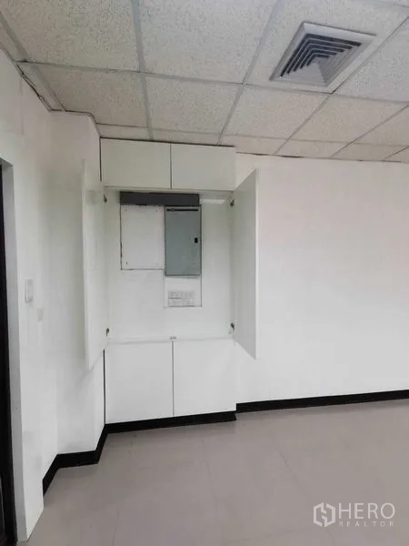 办公空间 出租在Watthana, Bangkok - 白墙角落的配电柜与天花送风口。