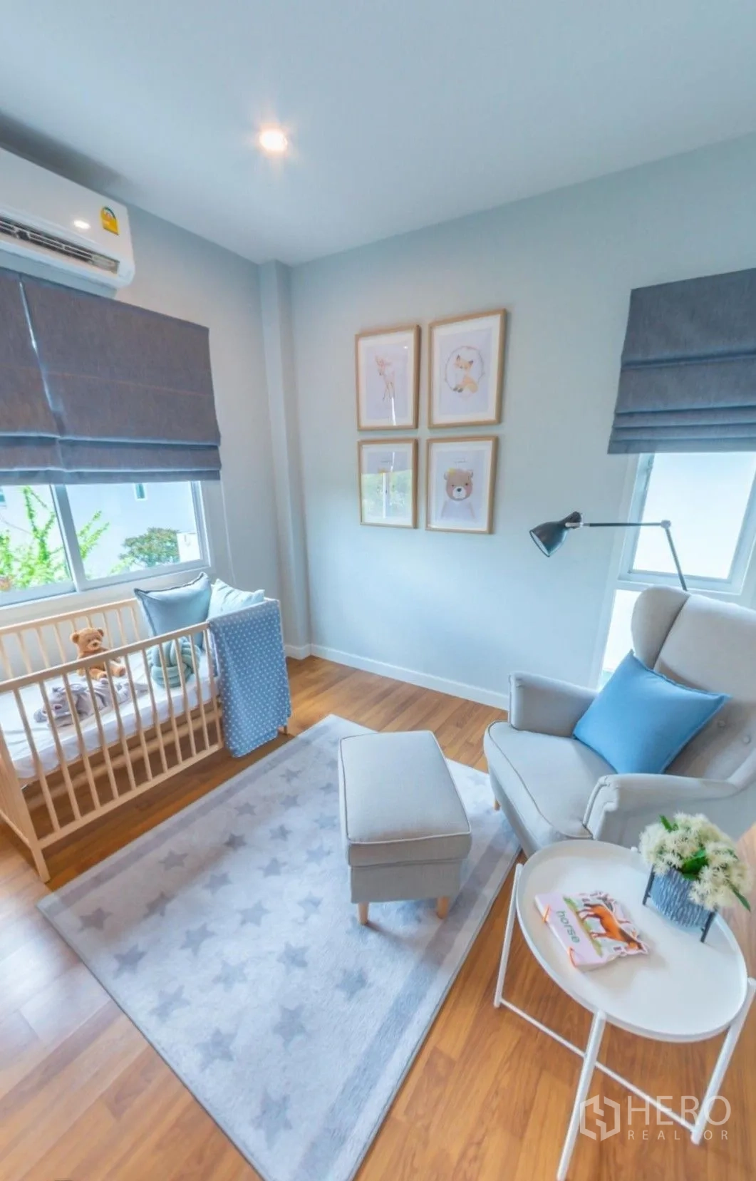 独栋房屋 for rent in Lam Luk Ka, Pathum Thani - 采光明亮的婴儿房，配婴儿床、扶手椅、墙面装饰画与百叶帘窗。