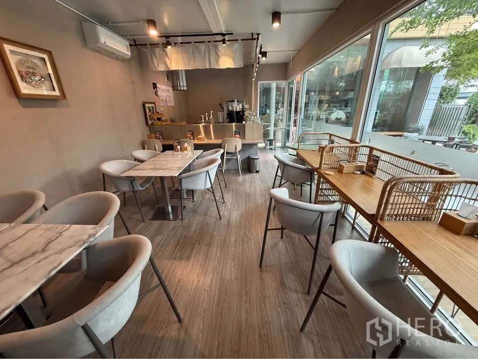 Retail Space for rent in Watthana, Bangkok - Main dining room with marble-top tables, grey chairs, and wide windows.