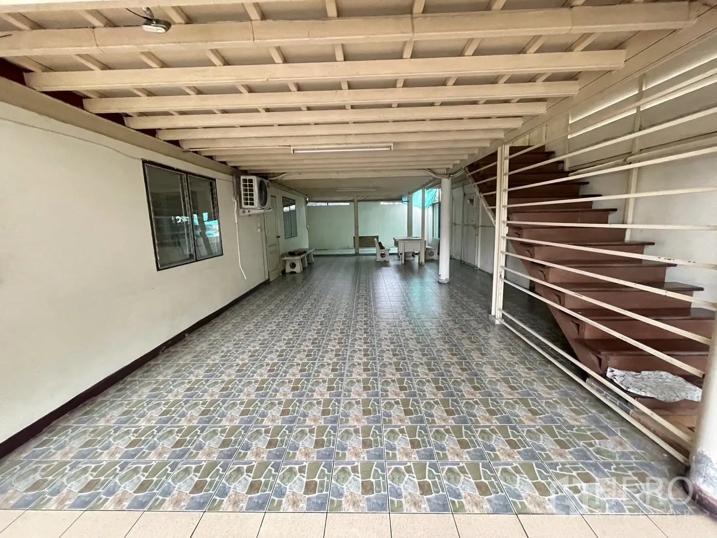 货栈 出租在Lat Phrao, Bangkok - 一层长形作业区，拼花地砖与金属楼梯。