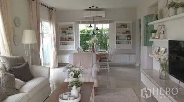 Detached House for rent in Bang Bo, Samut Prakan - Open-plan living and dining room with large windows and garden view.