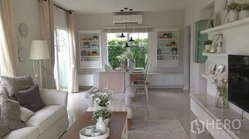 Detached House for rent in Bang Bo, Samut Prakan - Open-plan living and dining room with large windows and garden view.