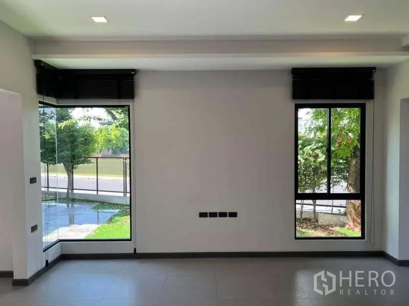 Detached House for rent or sale in Bang Phli, Samut Prakan - Close‑up of floor‑to‑ceiling windows facing the street and trees.