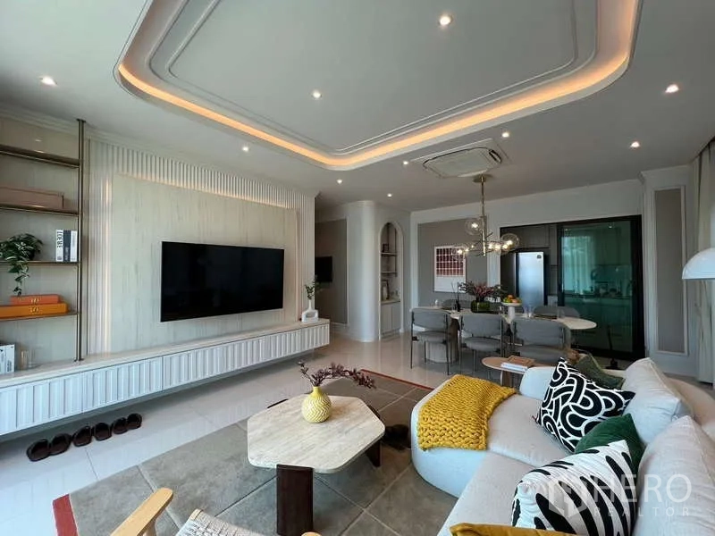 Detached House for sale in Saphan Sung, Bangkok - Bright living area with built-in media wall, sectional sofa and recessed lighting.