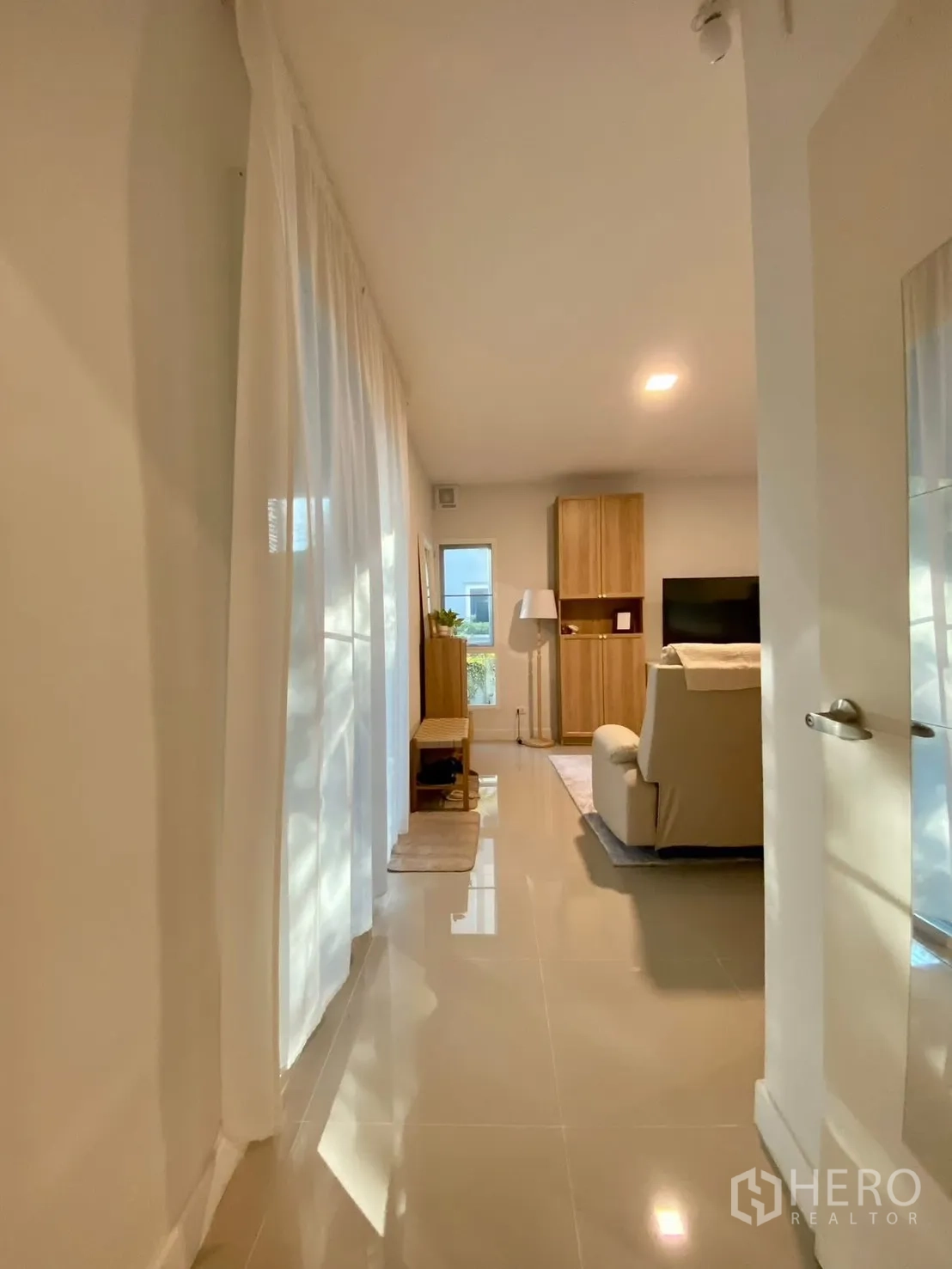 Semi-detached House for rent in Bang Phli, Samut Prakan - Hallway with sheer curtains leading to the lounge and garden access.