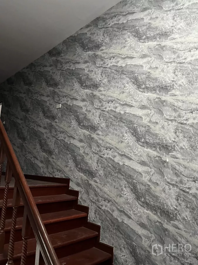 บ้าน ให้เช่าในWatthana, Bangkok - บันไดไม้ขัดเงาภายในบ้าน คู่กับผนังลายหินอ่อนสีเทา.