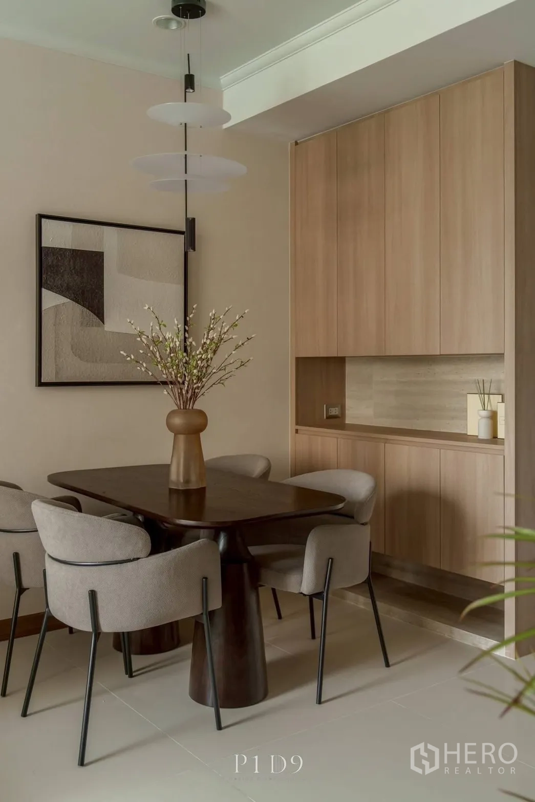 Condominium for rent in Watthana, Bangkok - Dining corner with wood cabinetry and soft under-cabinet lighting.
