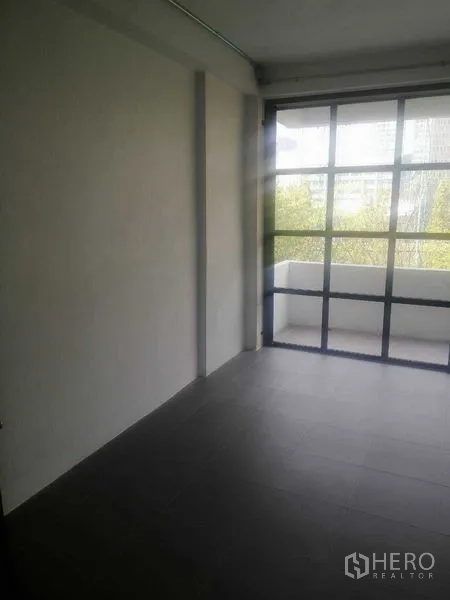 Shophouse for rent in Khlong Toei, Bangkok - Bright room with balcony access and gray floor tiles.