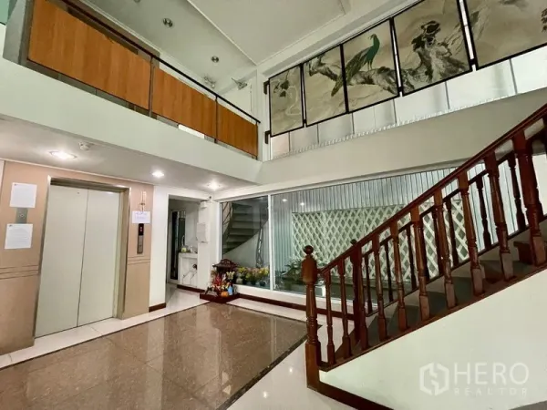 Office Space for rent in Bang Rak, Bangkok - Lobby of Silom office building with elevator, wooden staircase and mezzanine.