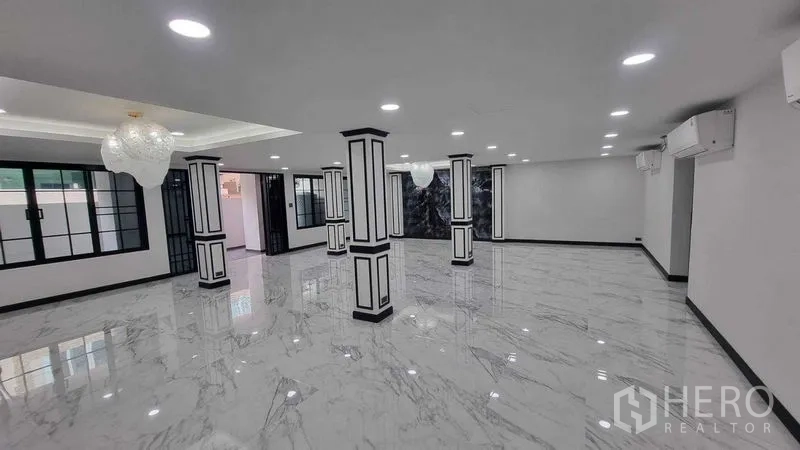 ทาวน์เฮาส์ ให้เช่าในKhlong Toei, Bangkok - โถงรับแขกโอ่โถง พื้นกระเบื้องลายหินอ่อน เสากรอบขาว และโคมไฟ