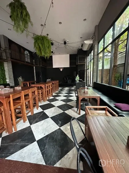 Retail Space for rent in Suan Luang, Bangkok - Interior dining hall with checkerboard floor, tall windows and bar-height tables.