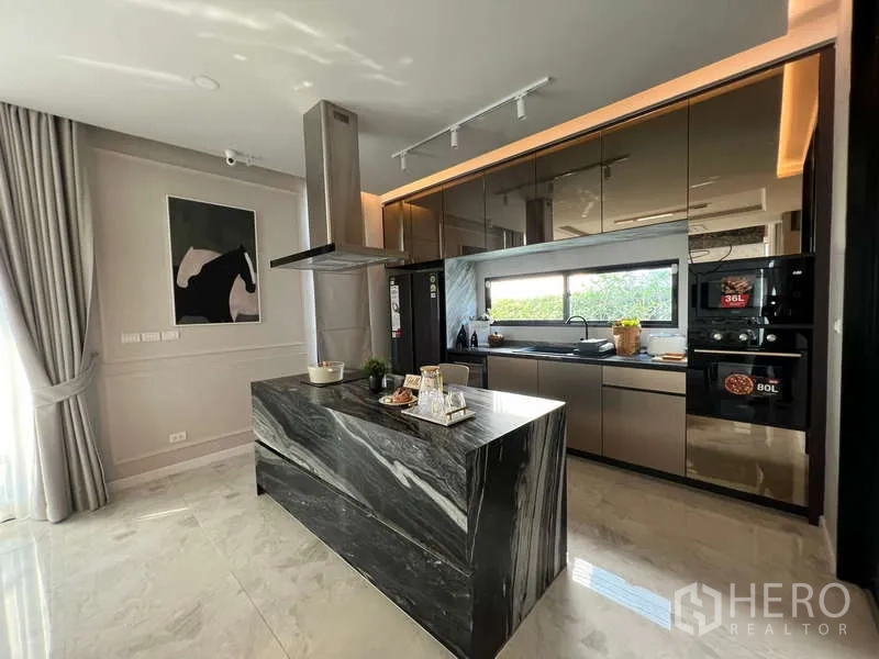 Detached House for sale in Suan Luang, Bangkok - Main kitchen with black marble island, high-gloss cabinets and window