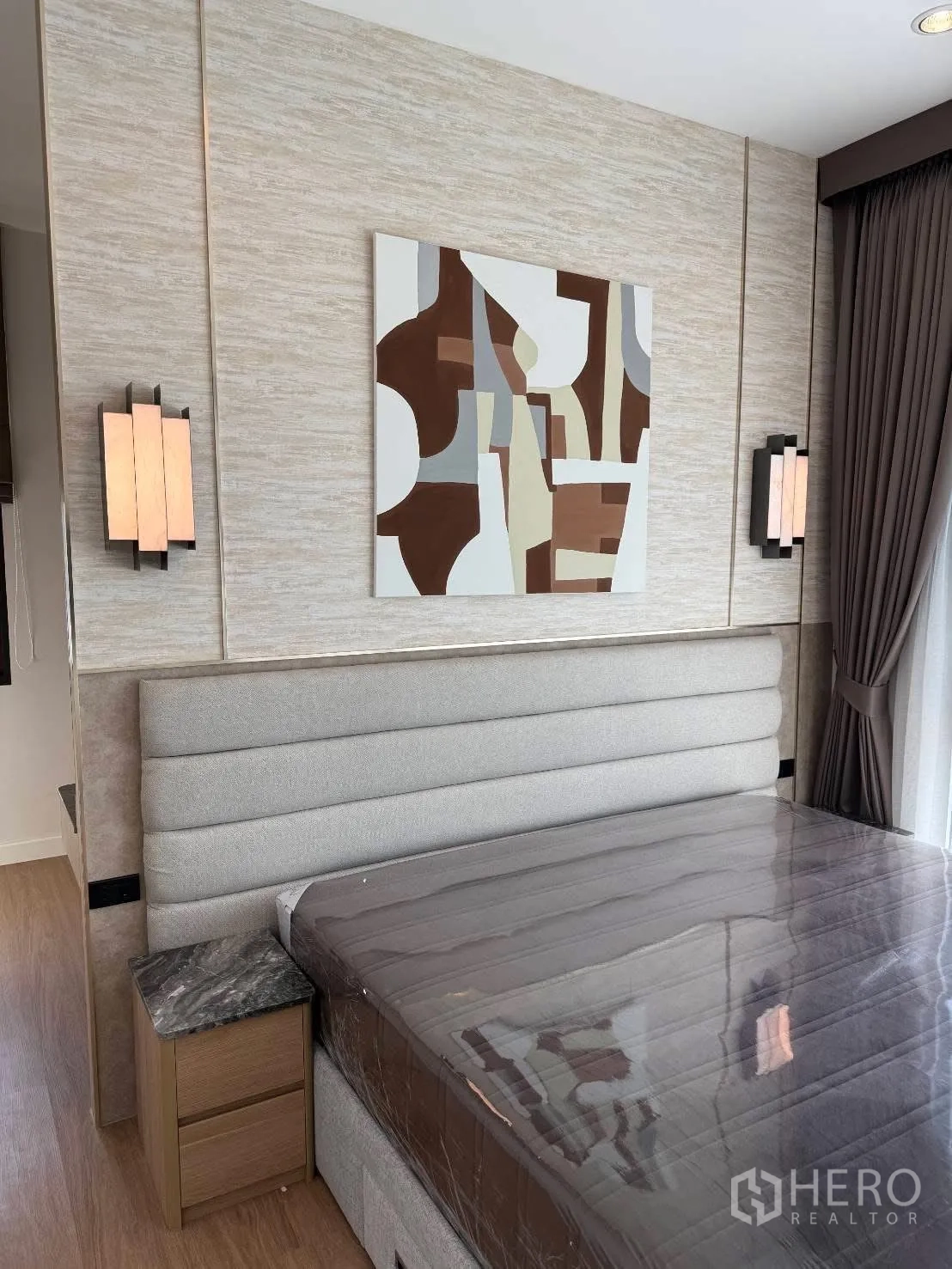 Detached House for rent in Bang Phli, Samut Prakan - Detail of padded headboard, bedside table with marble top, and abstract wall art.