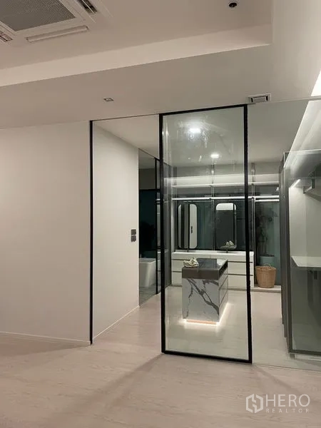 Detached House for sale in Saphan Sung, Bangkok - Minimalist dressing room with glass partition and marble island in a Saphan Sung detached house.