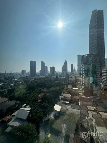 Condominium for rent - Panoramic city skyline under midday sun seen from the condo window.
