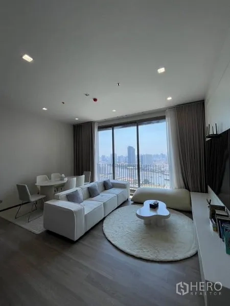 Condominium for rent in Bang Kho Laem, Bangkok - Living room from another angle showing dining set and skyline view.