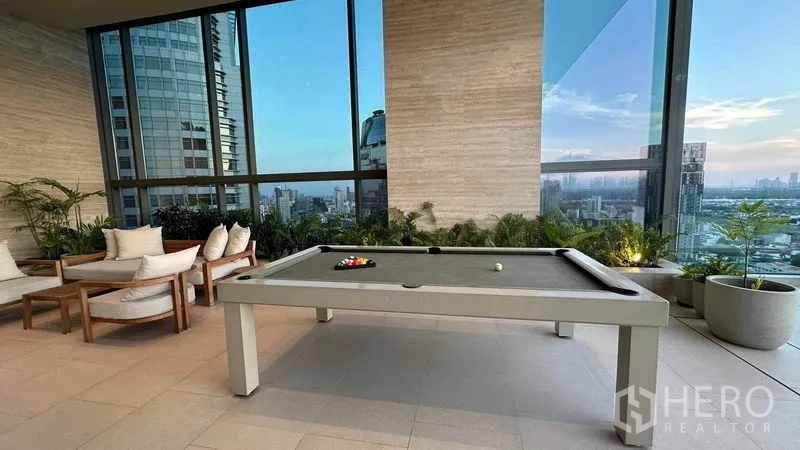Condominium for sale - Residents’ lounge with pool table and seating facing city vistas.
