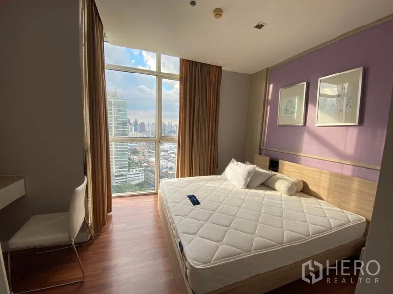 Condominium for rent in Watthana, Bangkok - Master bedroom with large window, purple accent wall, wood flooring and panoramic city skyline view
