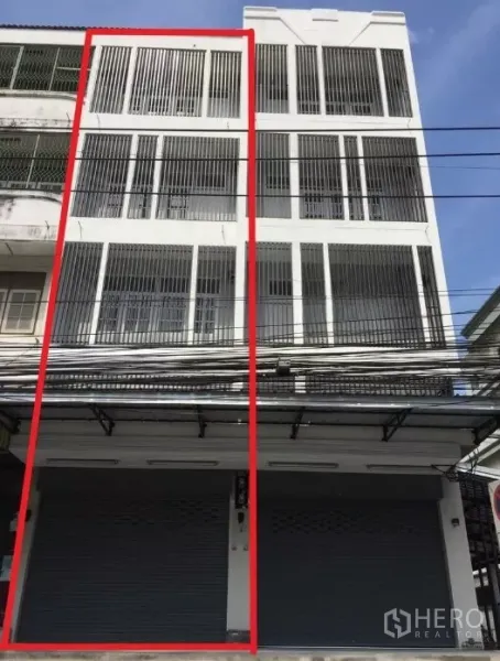 店屋 出租在Suan Luang, Bangkok - 四层白色临街商住楼外立面，带金属卷闸门与竖向护栏，位于On Nut区域。